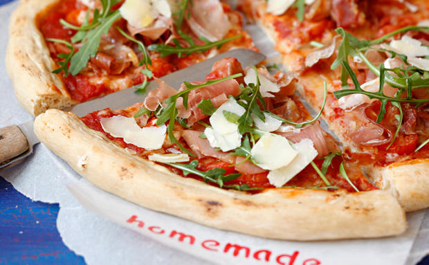 Pizza mit Schinken, Rucola und Parmesan